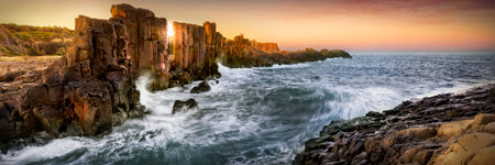 waves crash in at sunset at Bombo Quarry. Golden light  at New South Wales, Australia. Shaun Trainer photography. Purchase fine art landscape photography prints. Luxury Interior design ideas.