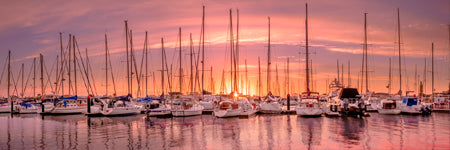 Amazing sunset colours at coolum boat harbour looking at the boats and reflection on the still waters. Brisbane, Queensland, Australia. Panoramic photograph, Shaun Trainer photography. Purchase fine art landscape photography prints. Luxury Interior design ideas.