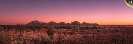 Limited edition print. Sunrise creates amazing colors in the sky and casts beautiful light across the red rock faces of kata tjuta, the olgas. Uluru Northern Territory Outback, Australia. Panoramic photograph, Shaun Trainer photography. Purchase fine art landscape photography prints. Luxury Interior design ideas.